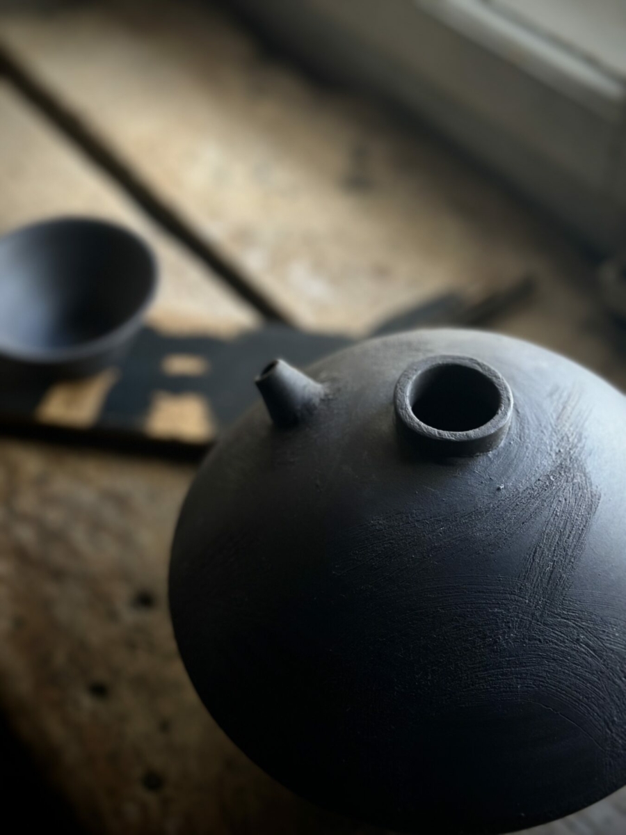 Vessels. Black porcelain with a wooden objet trouvé from the cellar, painted with acrylic. 2023/2024.